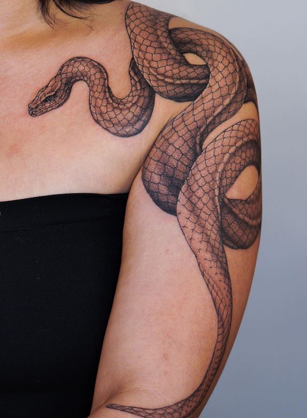 Snake tattoo on shoulder and arm