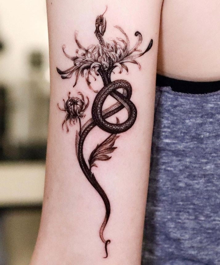 Floral snake tattoo on the arm 