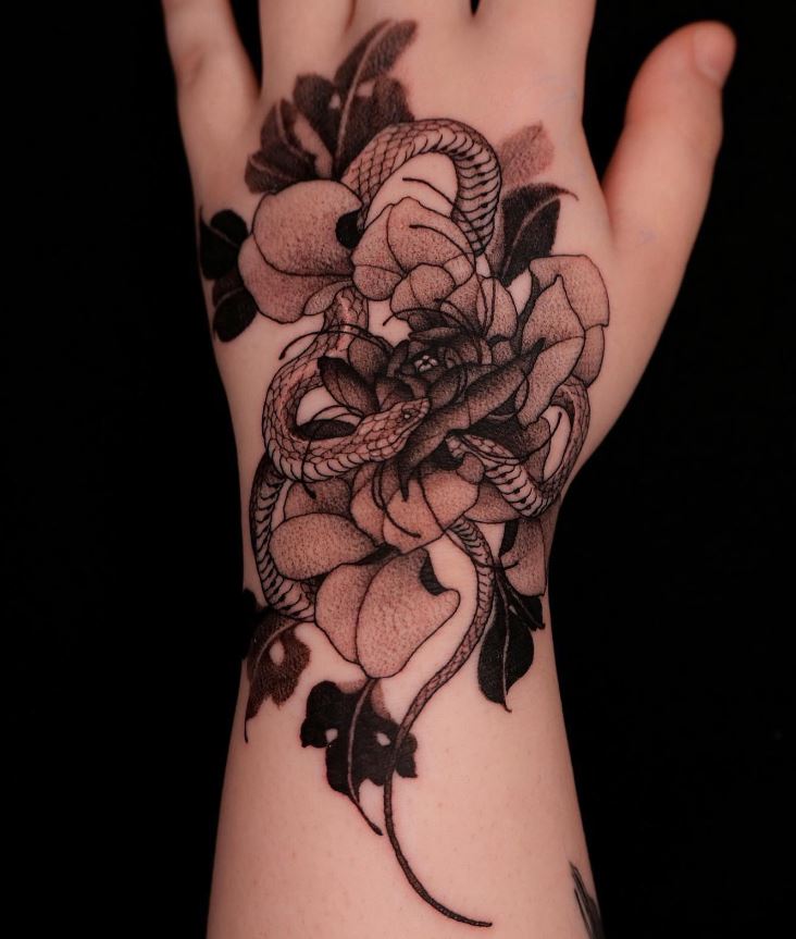 Snake and flowers tattoo on arm 