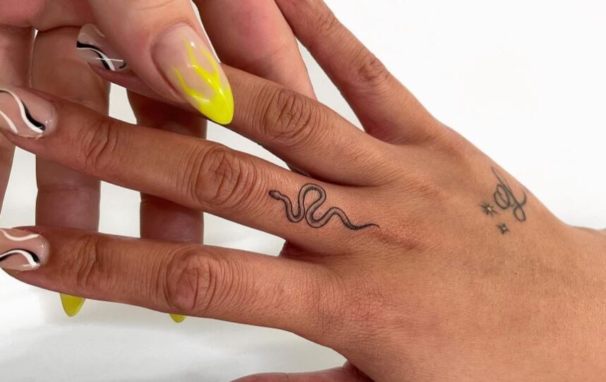 Minimalist snake tattoo on finger 