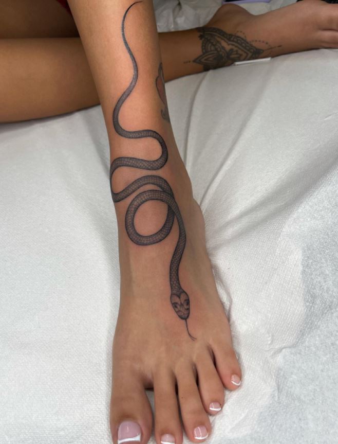 Snake tattoo on foot and leg 