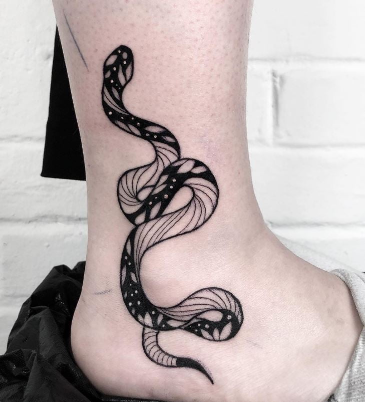 Black and white snake on ankle tattoo 