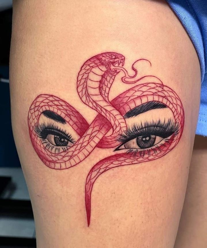     Red cobra and realistic eyes on thigh tattoo 
