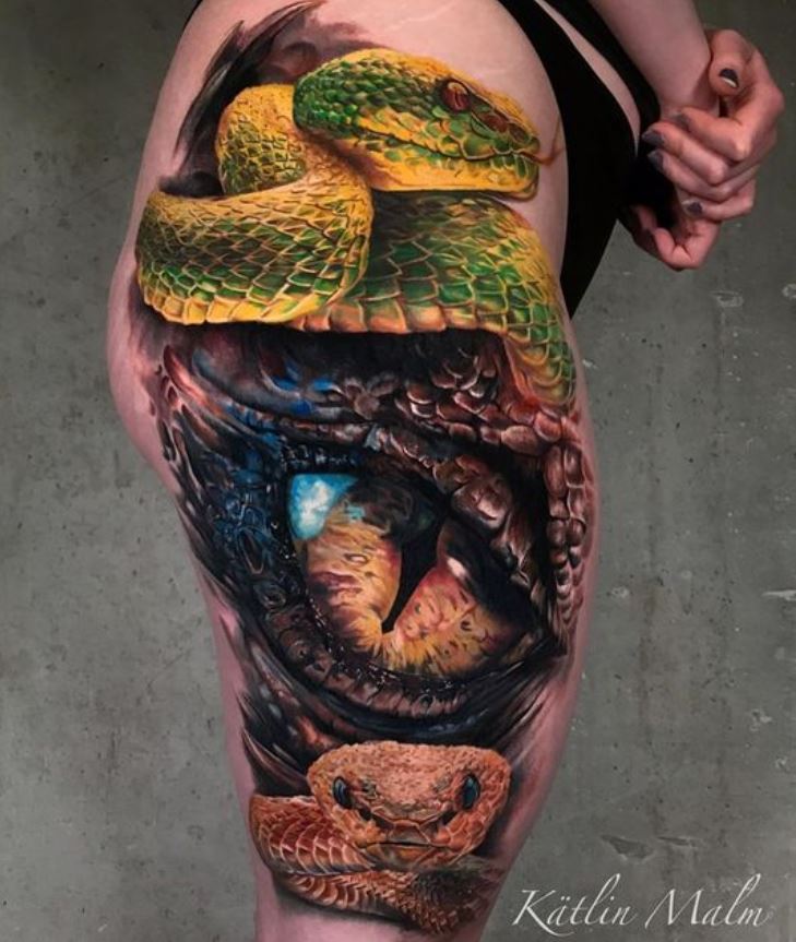     Colorful snake and eye tattoo on her thigh 