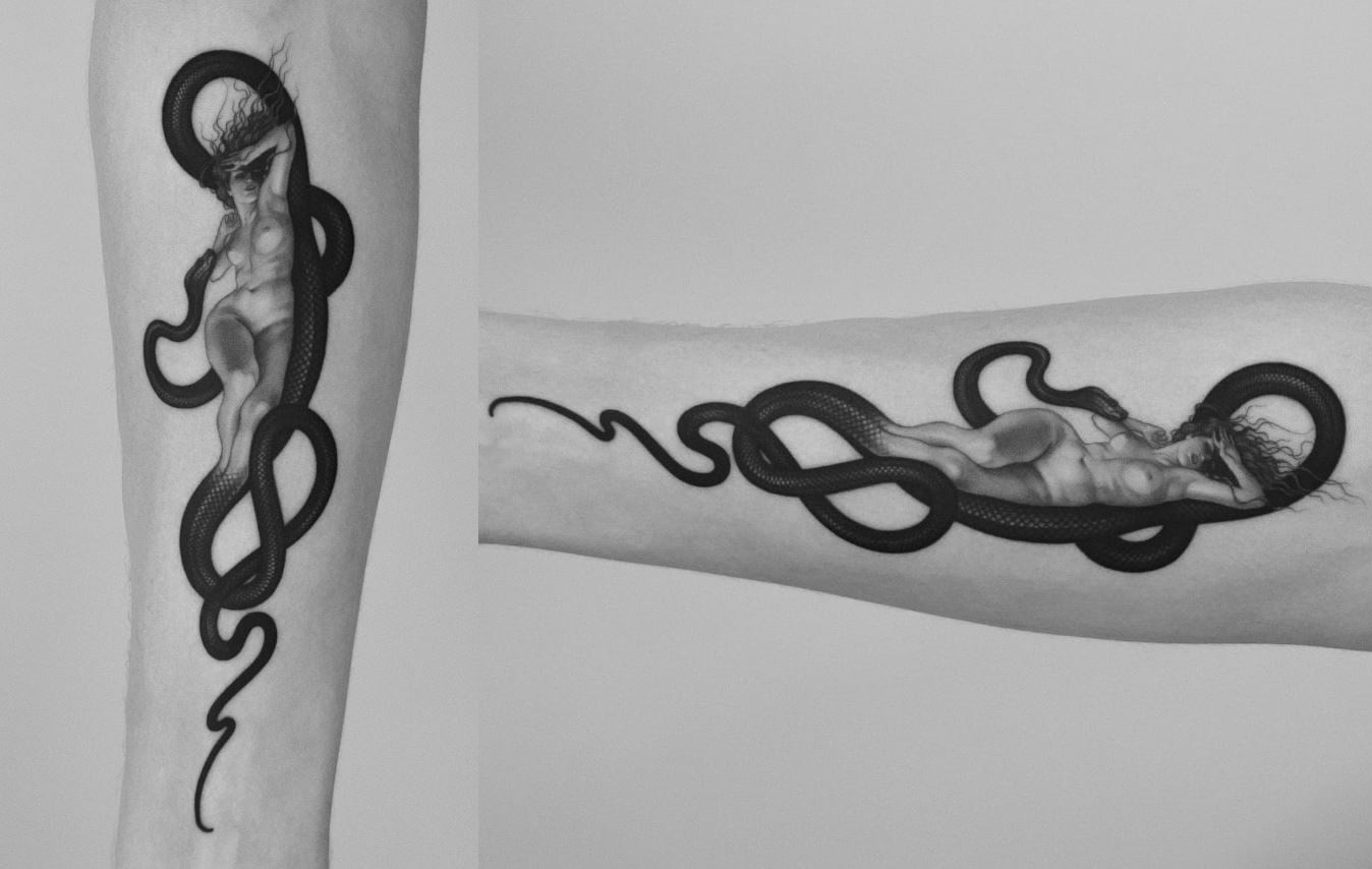 A tattoo of a snake and a naked woman 