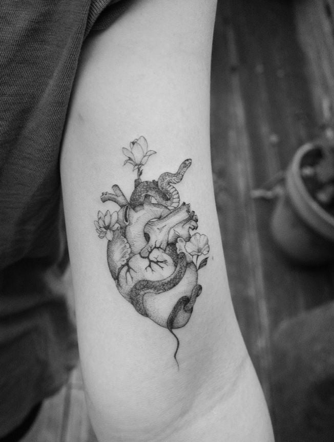 Anatomical heart and floral snake tattoo 