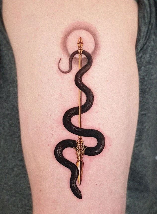 Black snake and gold spear tattoo 