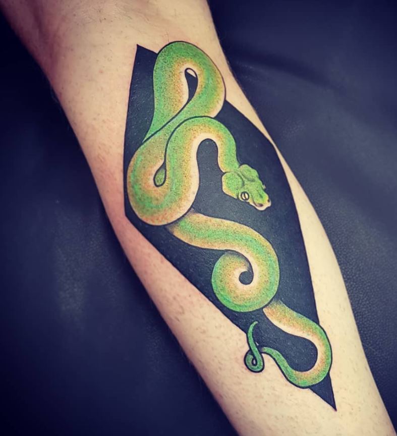 Tattoo on the body of a green python snake 