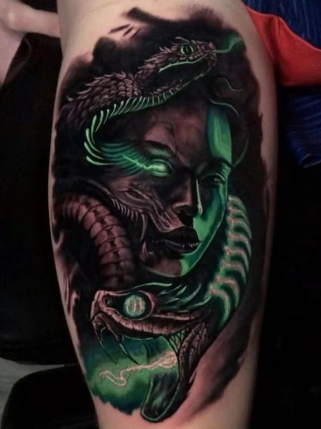 Two-tone tattoo of a snake and a woman 